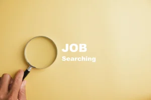 Magnifying glass highlighting the word 'Job' symbolizing the process of finding a job and advancing a career with Advanced Employment Services.