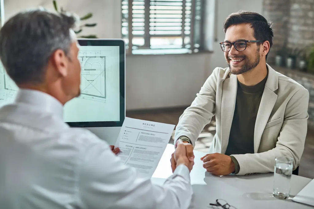 A job candidate shaking hands with an employer after a successful interview, representing the ease of the apply online process with Advanced Employment Services.